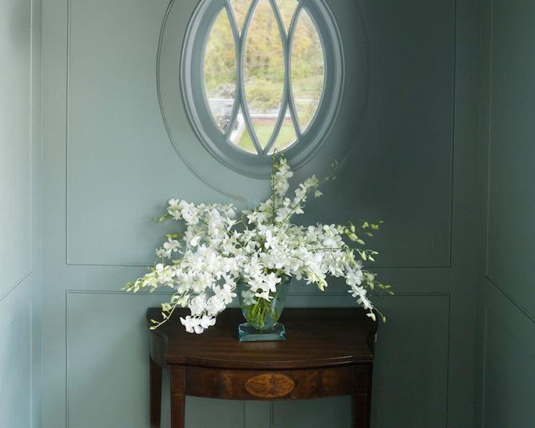 Hallway window with lillies and side table